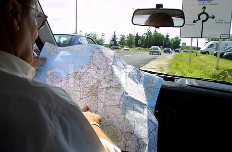 man-reading-map-in-car